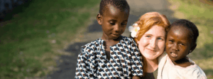 young smiling missionary with African children