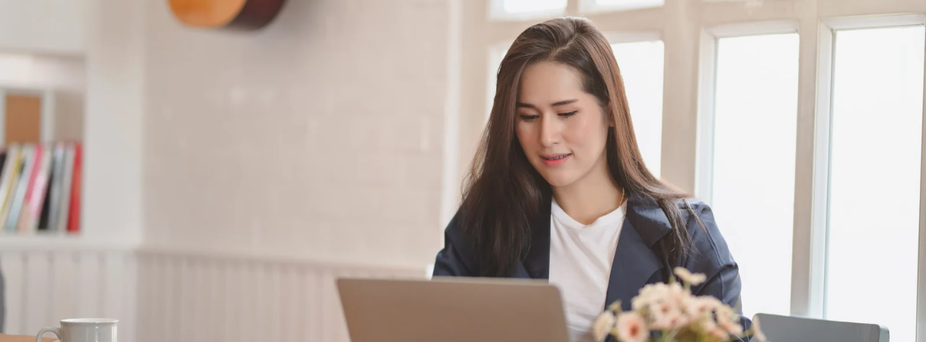 smiling woman using laptop computer
