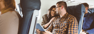 happy couple travelling by airplane together