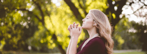 woman praying outdoors