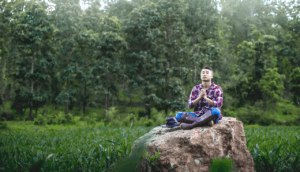 male farmer praying in cornfield